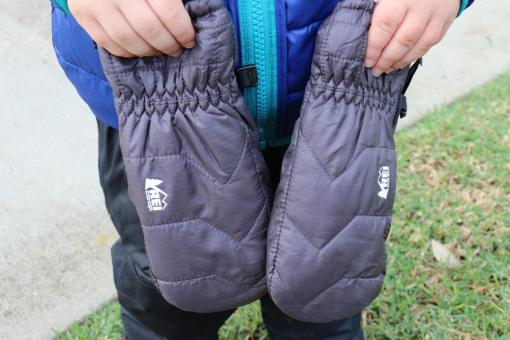 Hiking Toddler showing off his new REI Co-op Puffy Mitts.